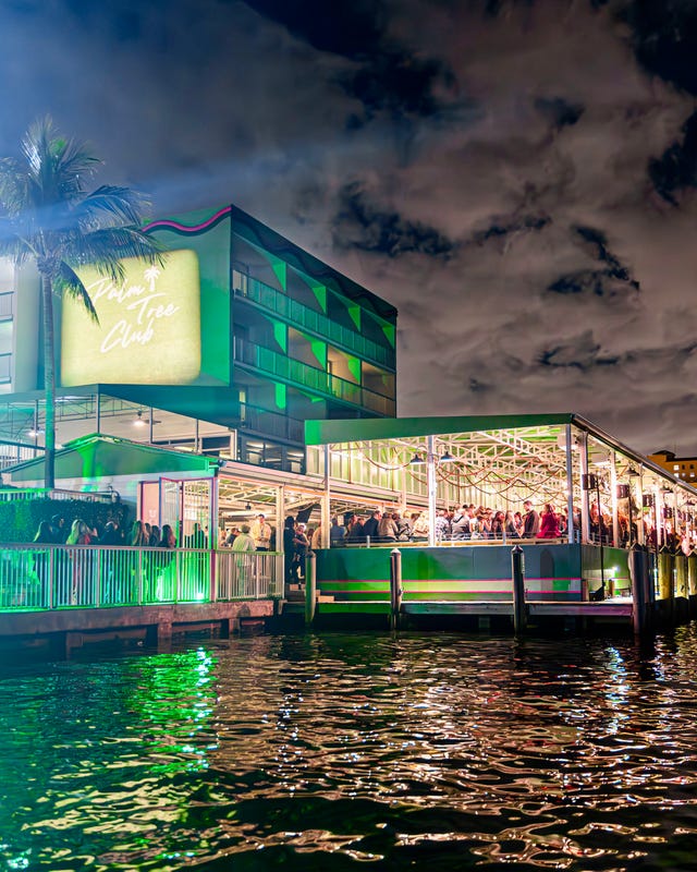 Nighttime view of a lively waterfront restaurant with outdoor seating. Nighttime view of a lively waterfront restaurant with outdoor seating.
