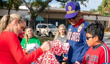 Pinellas military family serving during Season of Giving. Seen here are Christine Long, in red, and Mr. Springer’s granddaughter, handing out toys during the Bay Pines VA Adopt-a-Veteran program. (Courtesy: Bay Pines VA)
