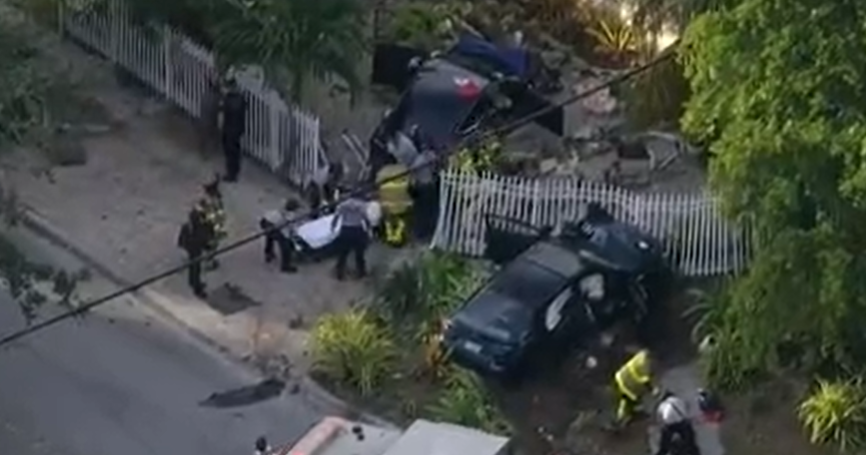 Four injured after two‑car crash tears through North Miami yard
