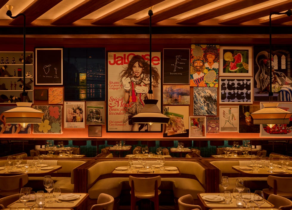 Interior of a restaurant featuring a gallery wall of eclectic artwork.