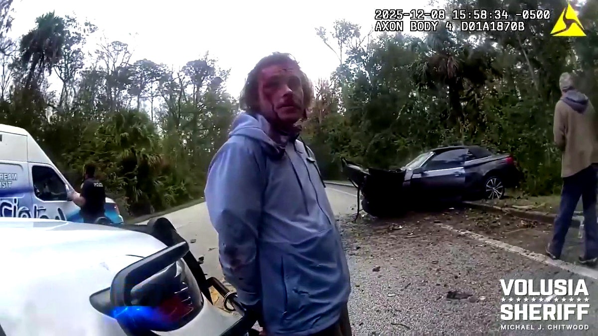 Calvin Curtis Johnson handcuffed outside patrol car