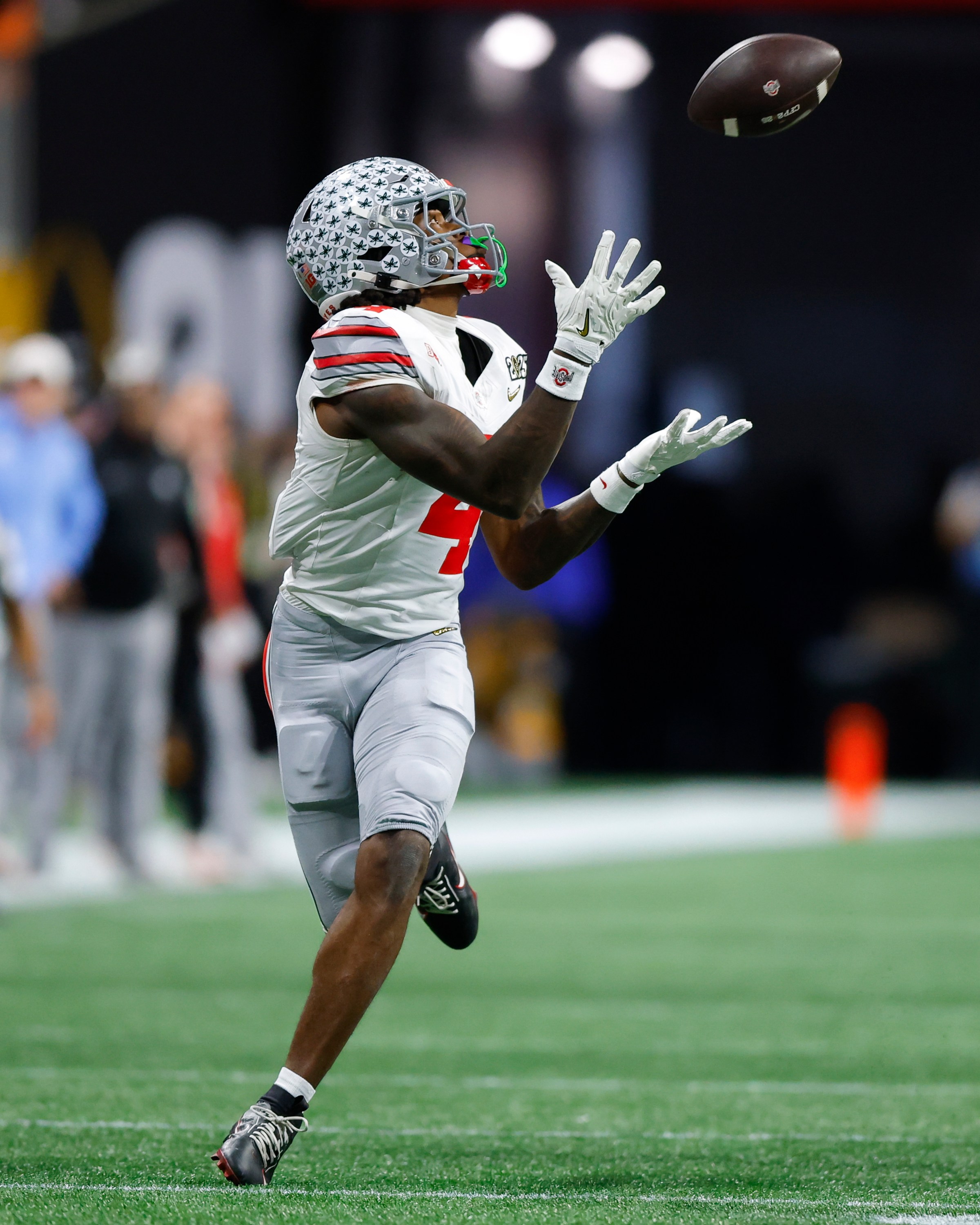 ATLANTA, GEORGIA - JANUARY 20: Jeremiah Smith #4 of the Ohio State Buckeyes makes a reception during the fourth quarter against the Notre Dame Fighting Irish in the 2025 CFP National Championship at Mercedes-Benz Stadium on January 20, 2025 in Atlanta, Georgia. (Photo by Todd Kirkland/Getty Images)