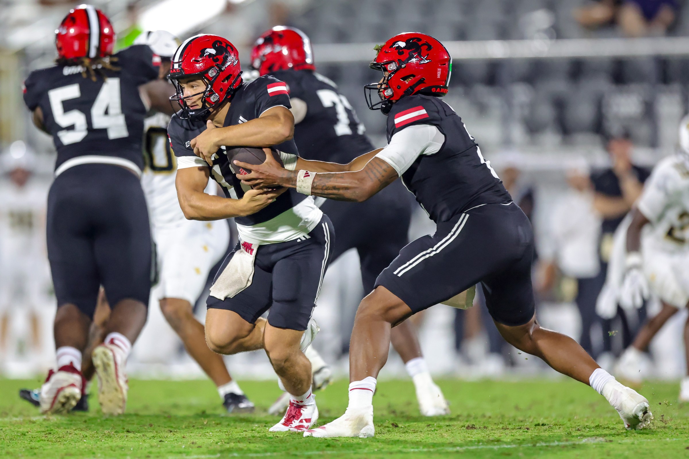 ORLANDO, FLORIDA - AUGUST 28: Gavin Wimsatt #2 fakes a handoff to Caden Creel #12 of the Jacksonville State Gamecocks at FBC Mortgage Stadium on August 28, 2025 in Orlando, Florida. (Photo by Dustin Markland/Getty Images)