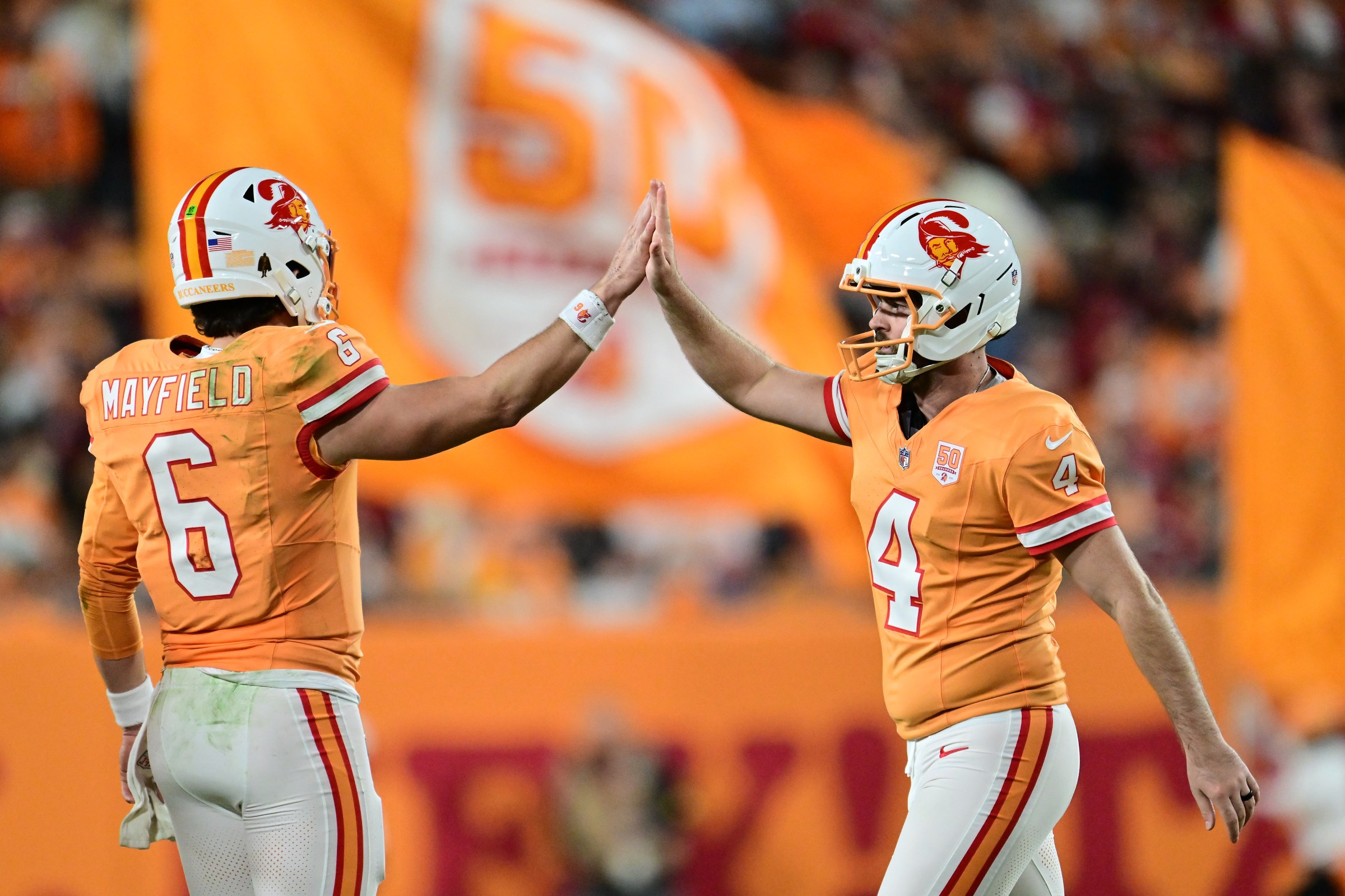 TAMPA, FLORIDA - DECEMBER 11: Baker Mayfield #6 and Chase McLaughlin #4 of the Tampa Bay Buccaneers react during the second quarter against the Atlanta Falcons at Raymond James Stadium on December 11, 2025 in Tampa, Florida. (Photo by Julio Aguilar/Getty Images)