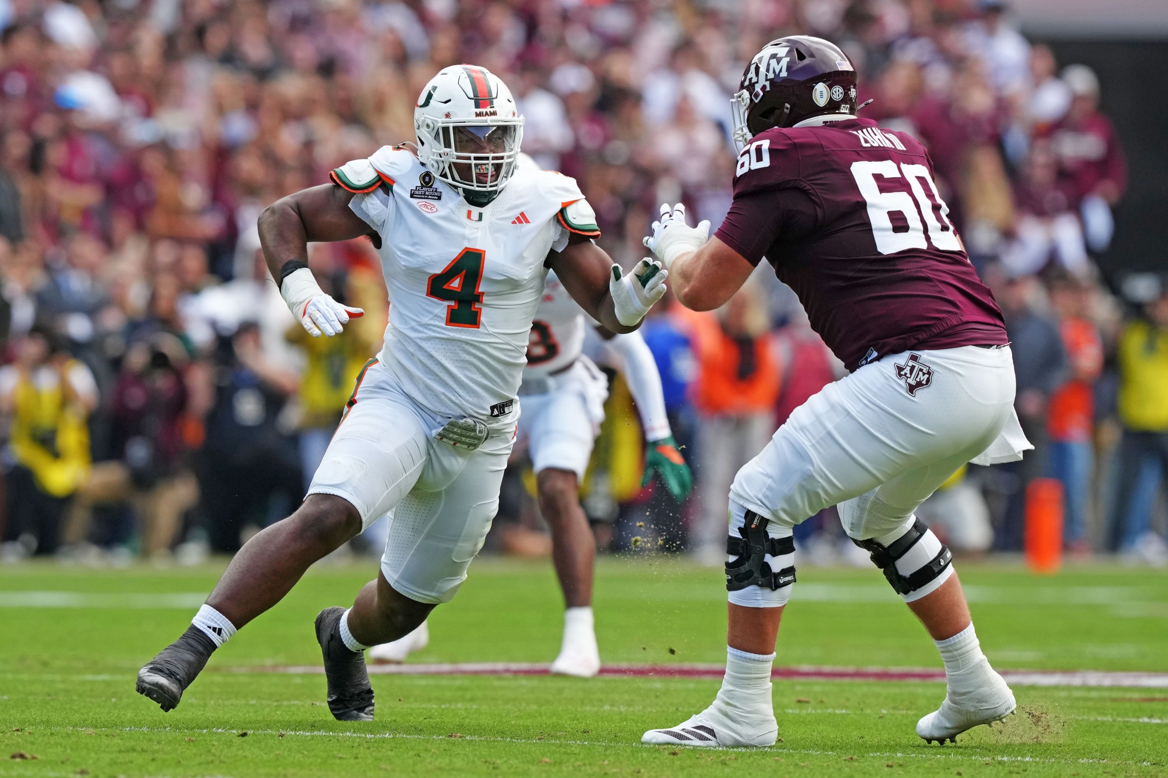COLLEGE STATION, TEXAS - DECEMBER 20: Rueben Bain Jr. (4) of the Miami (FL) Hurricanes and Trey Zuhn III (60) of the Texas A&M Aggies first half in a College Football Playoff First Round Game at Kyle Field on December 20, 2025 in College Station, Texas. (Photo by CFP/Getty Images)