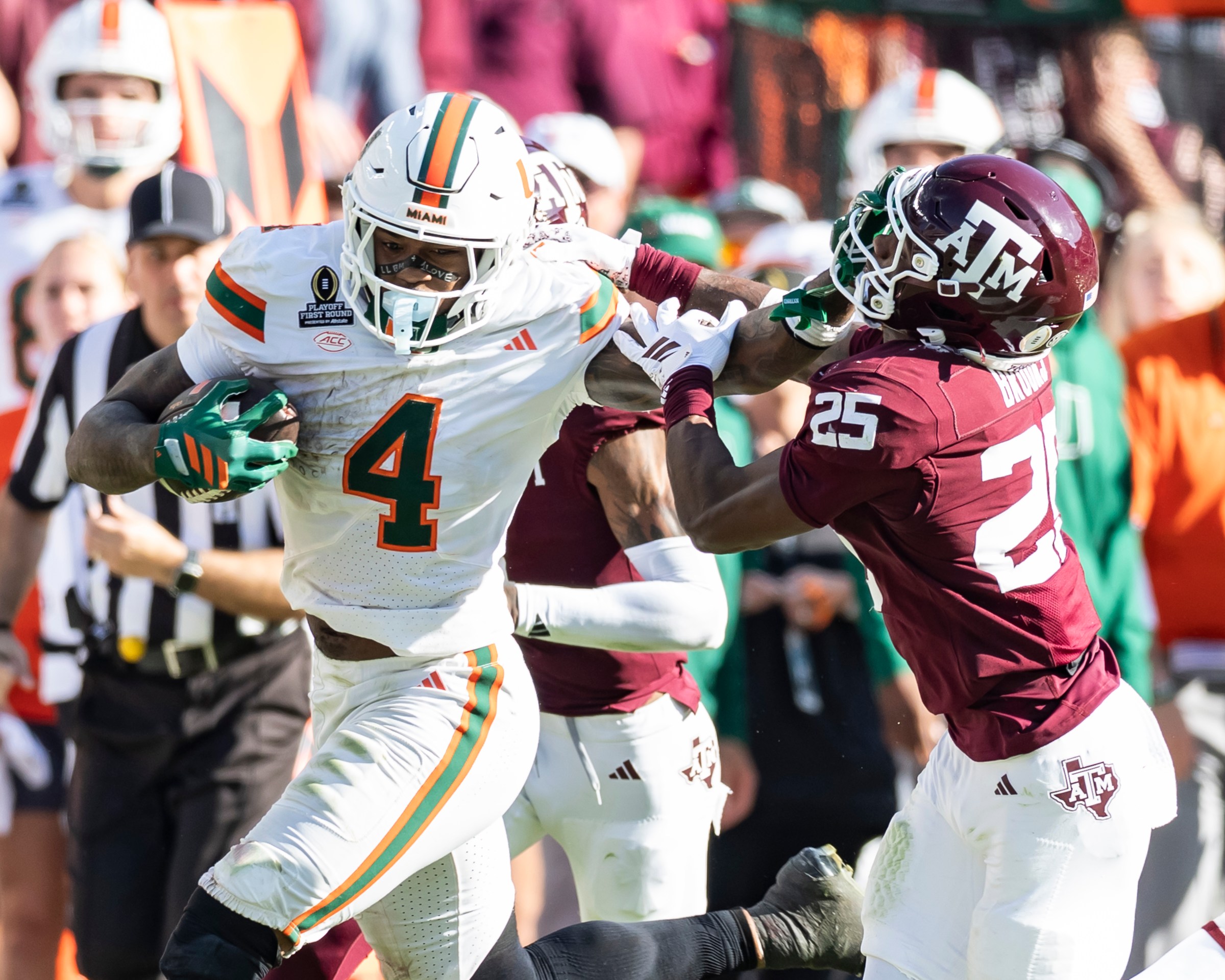 COLLEGE STATION, TEXAS - DECEMBER 20: Mark Fletcher Jr. #4 of the Miami (FL) Hurricanes straight arms Dalton Brooks #25 of the Texas A&M Aggies in the fourth quarter of the College Football Playoff First Round Game between the Texas A & M Longhorns and the Miami Hurricanes at Kyle Field on December 20, 2025 in College Station, Texas. (Photo by Steve Limentani/ISI Photos/ISI Photos via Getty Images)