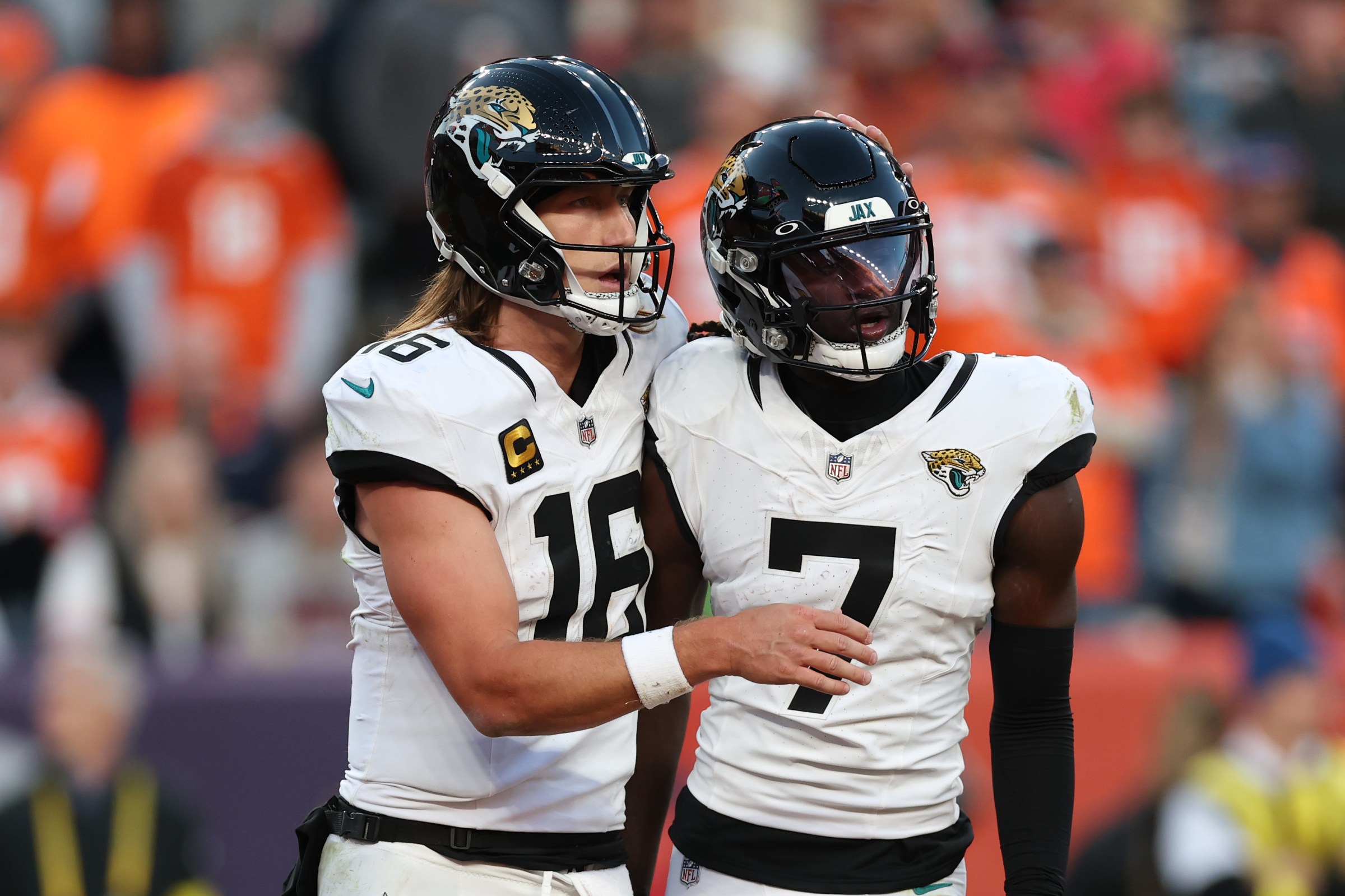DENVER, COLORADO - DECEMBER 21: Trevor Lawrence #16 celebrates a third quarter touchdown with Brian Thomas Jr. #7 of the Jacksonville Jaguars against the Denver Broncos at Empower Field At Mile High on December 21, 2025 in Denver, Colorado. (Photo by Matthew Stockman/Getty Images)