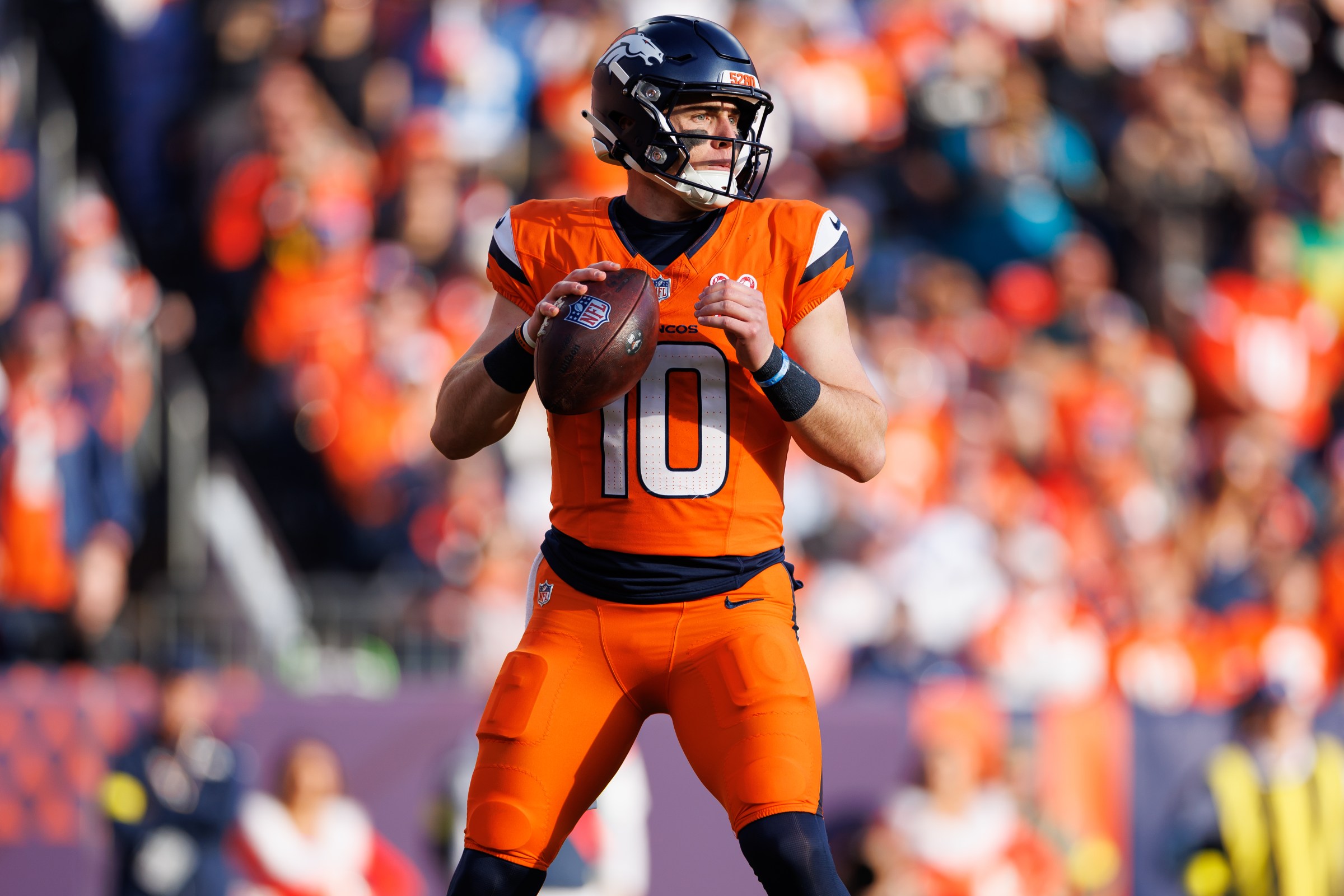 DENVER, COLORADO - DECEMBER 21: Bo Nix #10 of the Denver Broncos drops back to pass during the first quarter of an NFL football game against the Jacksonville Jaguars at Empower Field At Mile High on December 21, 2025 in Denver, Colorado. (Photo by Brooke Sutton/Getty Images)