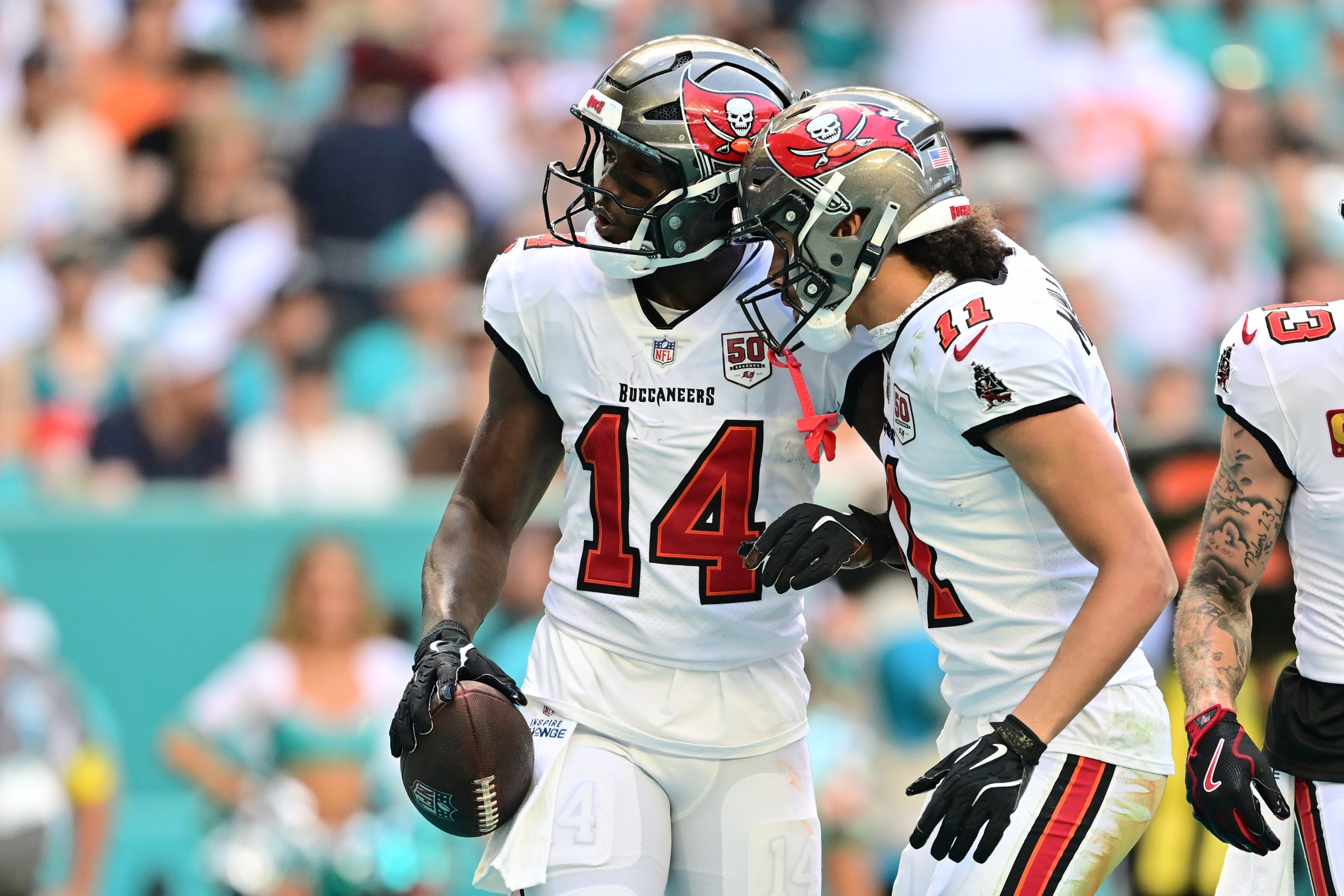MIAMI GARDENS, FLORIDA - DECEMBER 28: Chris Godwin Jr. #14 celebrates with Jalen McMillan #11 of the Tampa Bay Buccaneers after a first quarter touchdown against the Miami Dolphins at Hard Rock Stadium on December 28, 2025 in Miami Gardens, Florida. (Photo by Julio Aguilar/Getty Images)