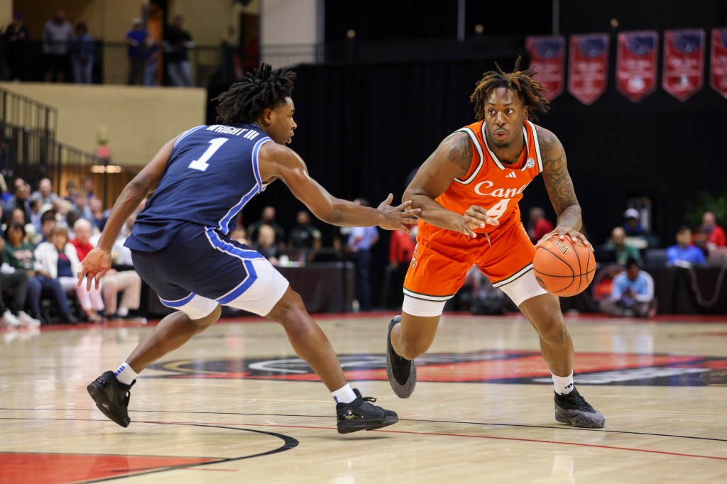 Miami (FL) Hurricanes guard Marcus Allen (4) is guarded by Brigham Young University Cougars guard Robert Wright III (1).