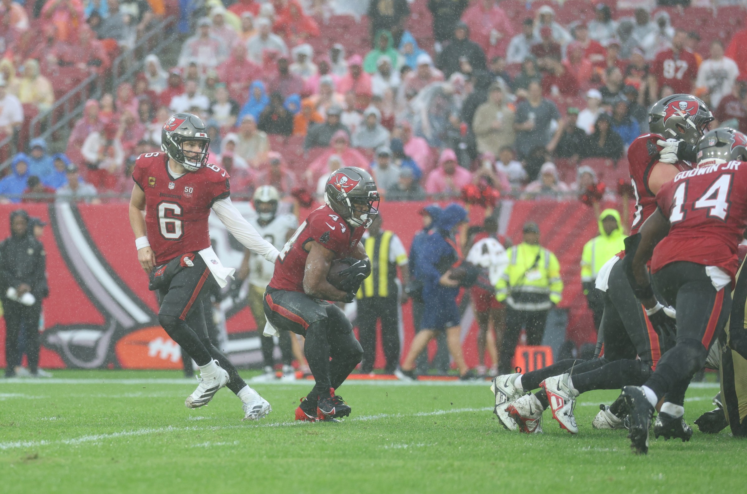Dec 7, 2025; Tampa, Florida, USA; Tampa Bay Buccaneers quarterback Baker Mayfield (6) hands the ball off to running back Sean Tucker (44) for a touchdown during the third quarter against the New Orleans Saints at Raymond James Stadium. Mandatory Credit: Nathan Ray Seebeck-Imagn Images