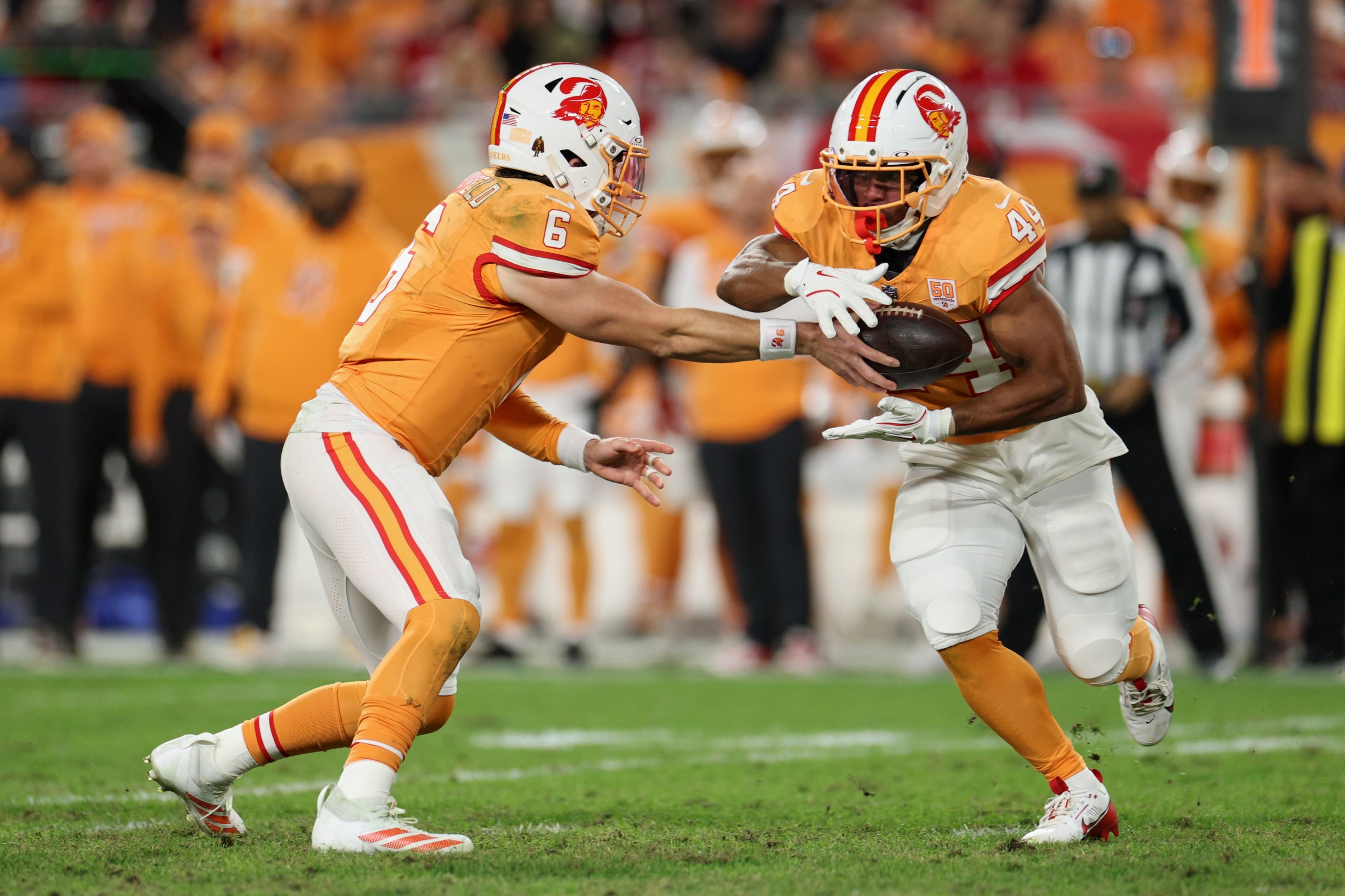 Dec 11, 2025; Tampa, Florida, USA; Tampa Bay Buccaneers quarterback Baker Mayfield (6) hands the ball off to running back Sean Tucker (44) against the Atlanta Falcons during the second quarter at Raymond James Stadium. Mandatory Credit: Nathan Ray Seebeck-Imagn Images