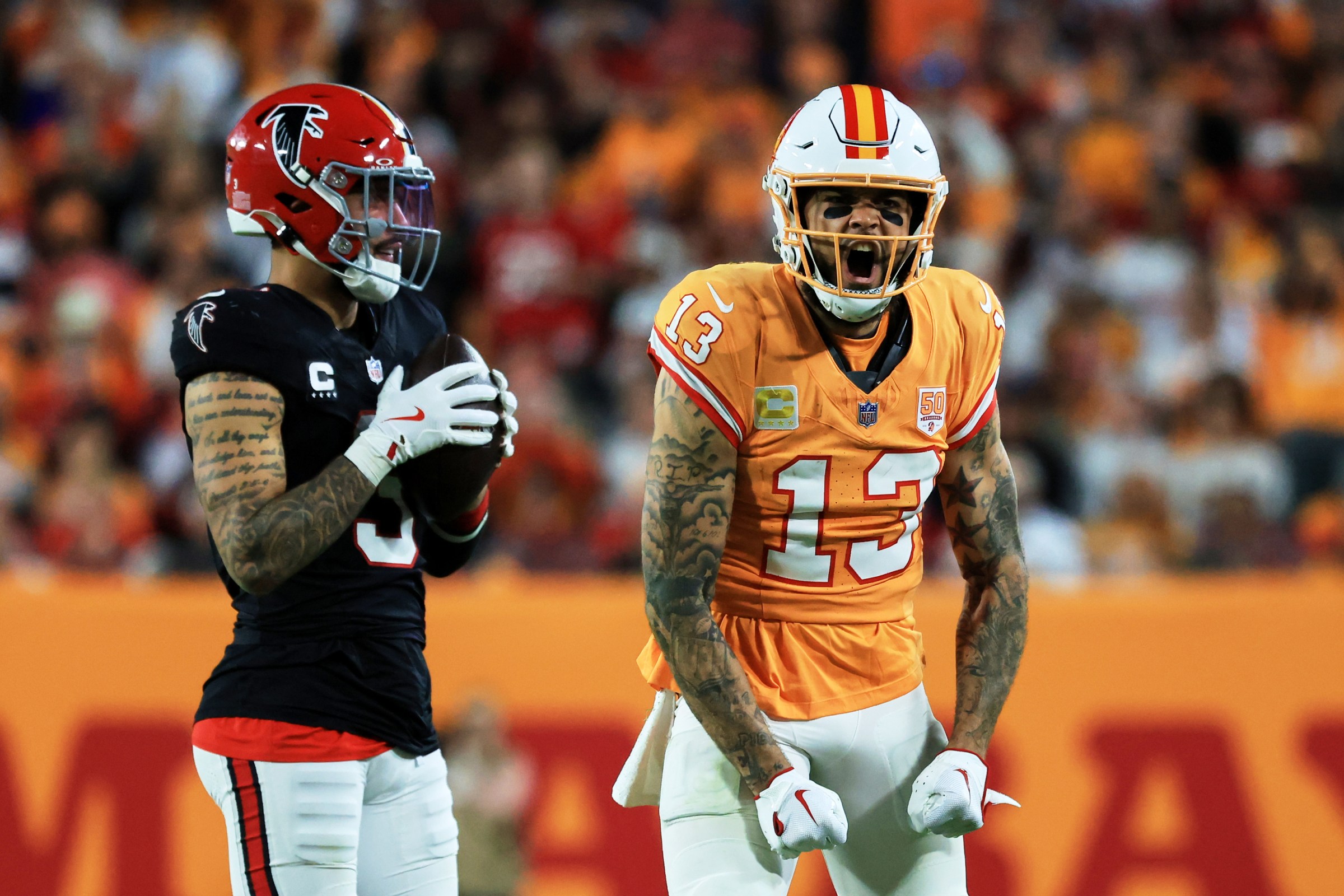 Dec 11, 2025; Tampa, Florida, USA; Tampa Bay Buccaneers wide receiver Mike Evans (13) reacts after catching a pass against Atlanta Falcons safety Jessie Bates III (3) (obscured) during the third quarter at Raymond James Stadium. Mandatory Credit: Kim Klement Neitzel-Imagn Images