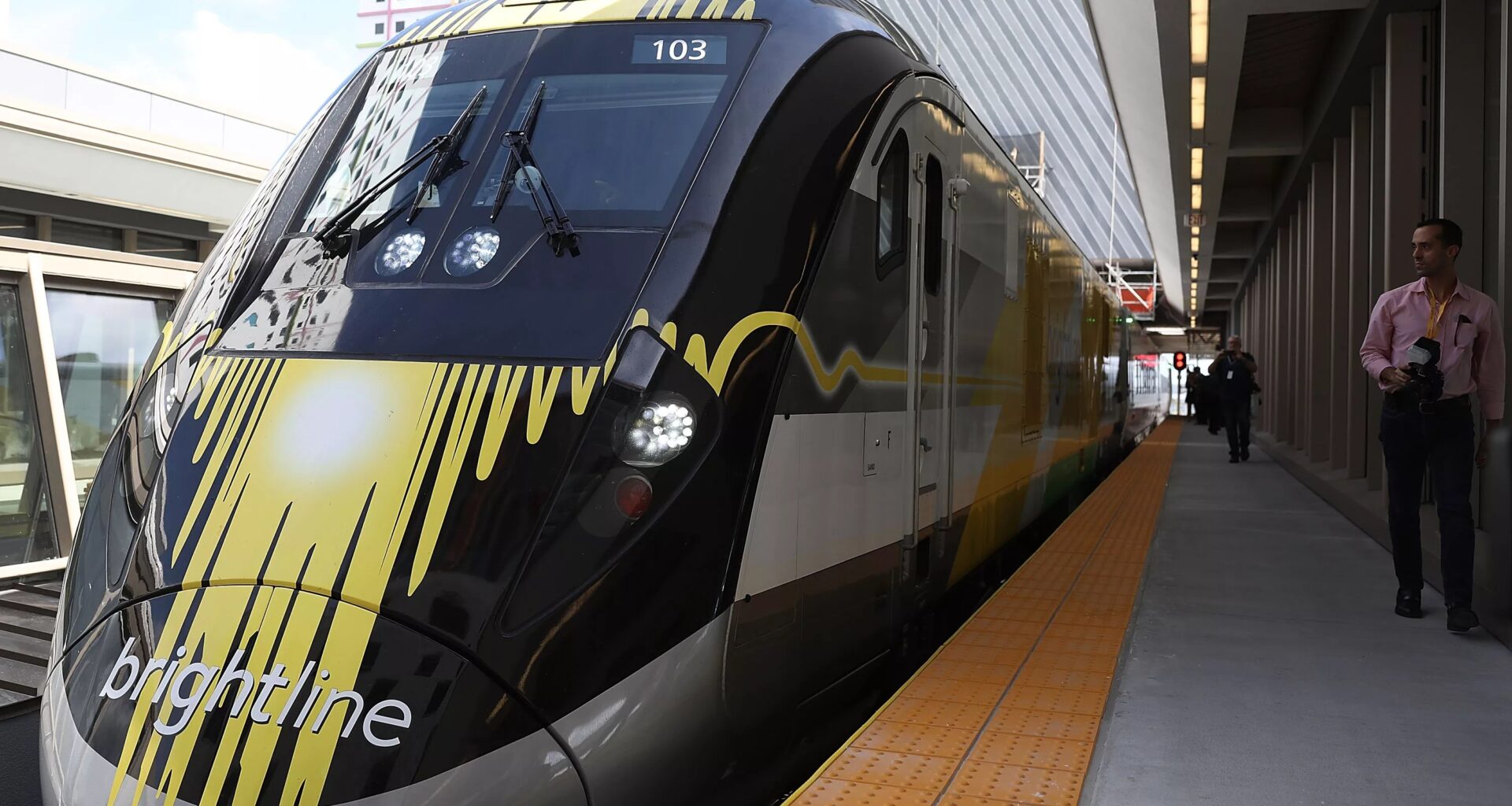 A brightline train sits on the platform