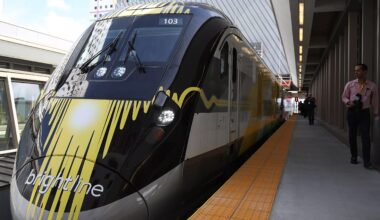 A brightline train sits on the platform