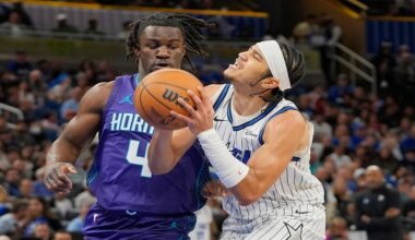 Orlando Magic guard Anthony Black, right, looks for a shot against Charlotte Hornets guard Sion James (4) during the first half of an NBA basketball game, Friday, Dec. 26, 2025, in Orlando, Fla. (AP Photo/John Raoux)