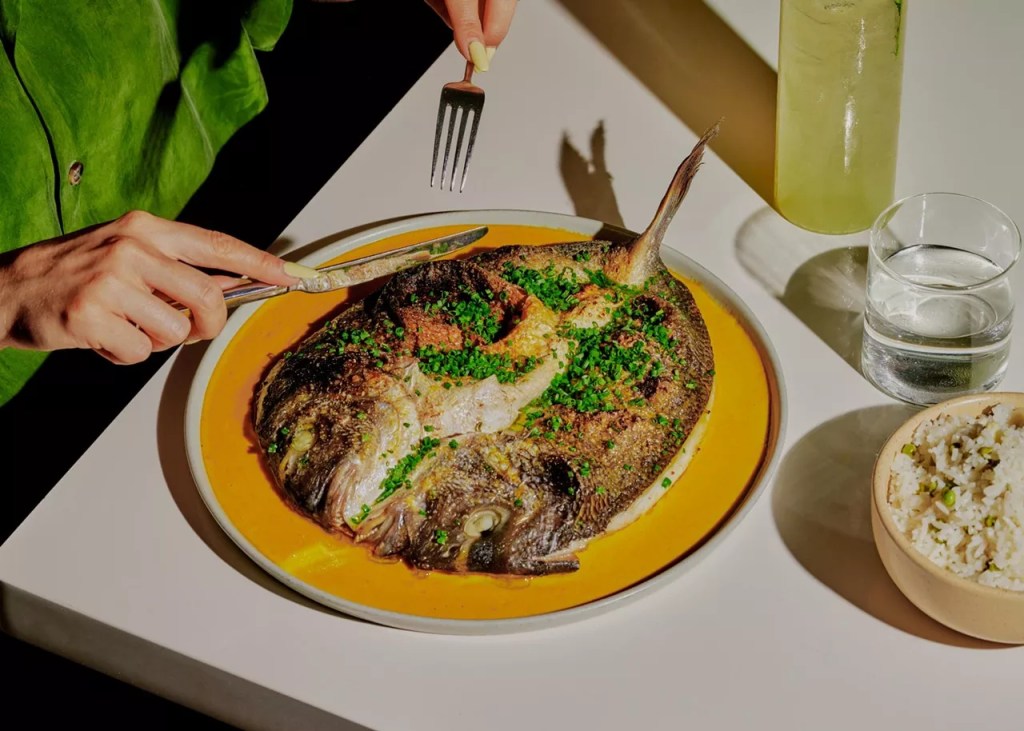 a fish dish on a yellow plate