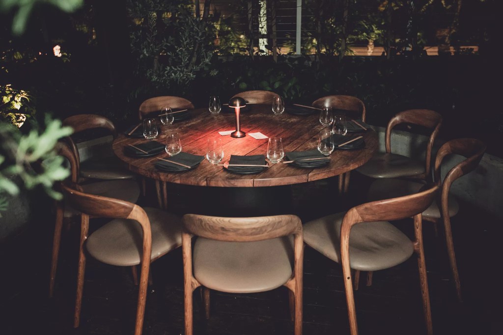a dining table with wooden chairs