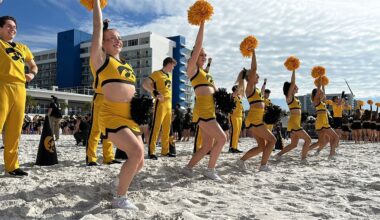 Iowa Hawkeyes cheerleaders peform on Clearwater Beach. (Spectrum News/Melissa Eichman)