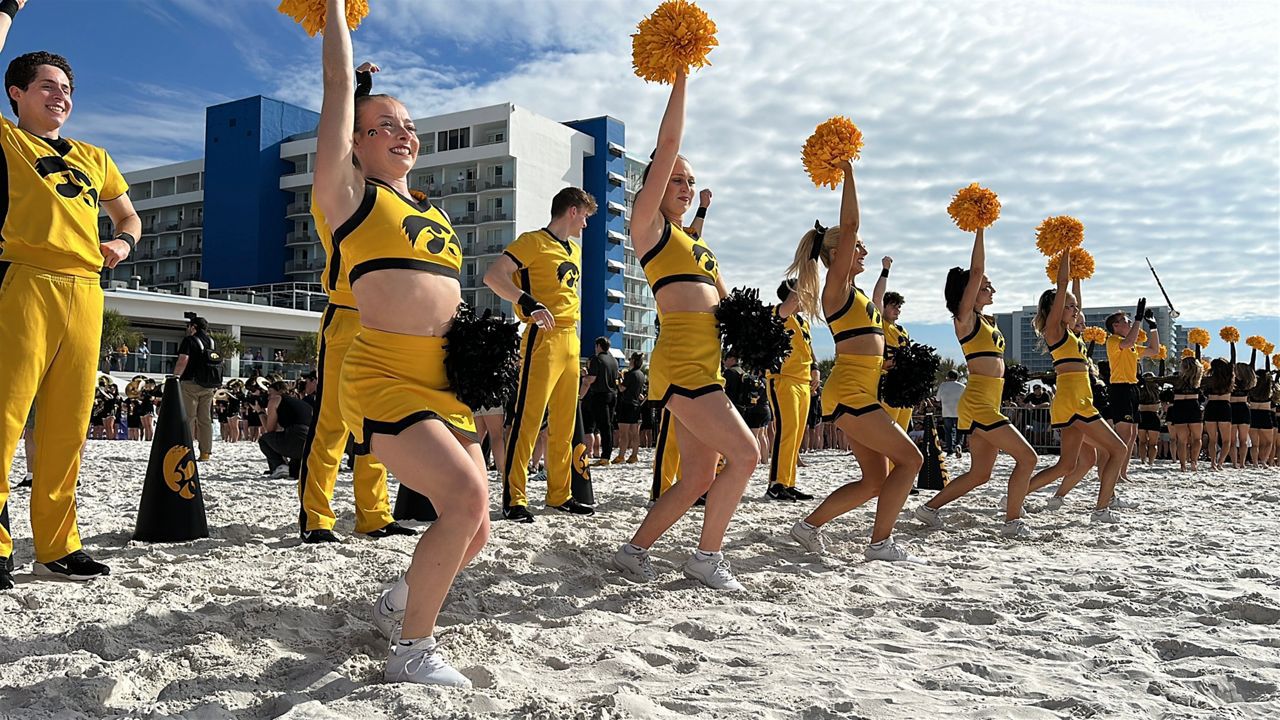 Iowa Hawkeyes cheerleaders peform on Clearwater Beach. (Spectrum News/Melissa Eichman)