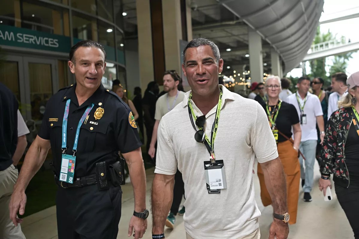 Miami Mayor Francis Suarez walking in the Paddock with a city of Miami police officer at the 2025 Miami Grand Prix.