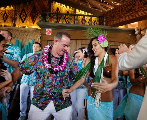 Mai-Kai managing partner Bill Fuller dances with a performer during the reopening ribbon-cutting ceremony at the Mai-Kai restaurant in Oakland Park on Thursday, Nov. 21, 2024. (Carline Jean/South Florida Sun Sentinel)