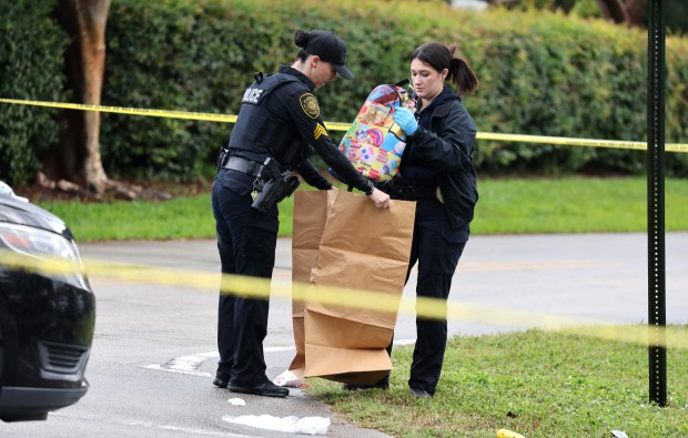 Plantation Police collect evidence at the scene of a shooting at the intersection of Northwest 70th Avenue and Northwest 16th Street in Plantation on Monday, December 8, 2025. A child was shot during a fight and taken to a hospital with non-life-threatening injuries. (Carline Jean/South Florida Sun Sentinel)