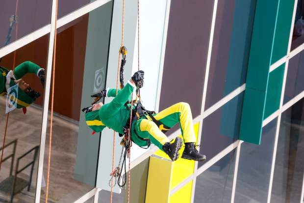 Alex "Fonzy" Ildefonso, from Orange County Fire Rescue, rappels down the side of AdventHealth for Children, interacting with children and their families through the windows on Thursday, December 18, 2025. (Rich Pope/Orlando Sentinel)