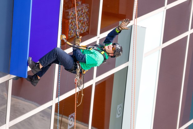 Orange County Fire Rescue and the Orlando Fire Department rappel down the side of AdventHealth for Children, interacting with children and their families through the windows on Thursday, December 18, 2025.(Rich Pope/Orlando Sentinel)