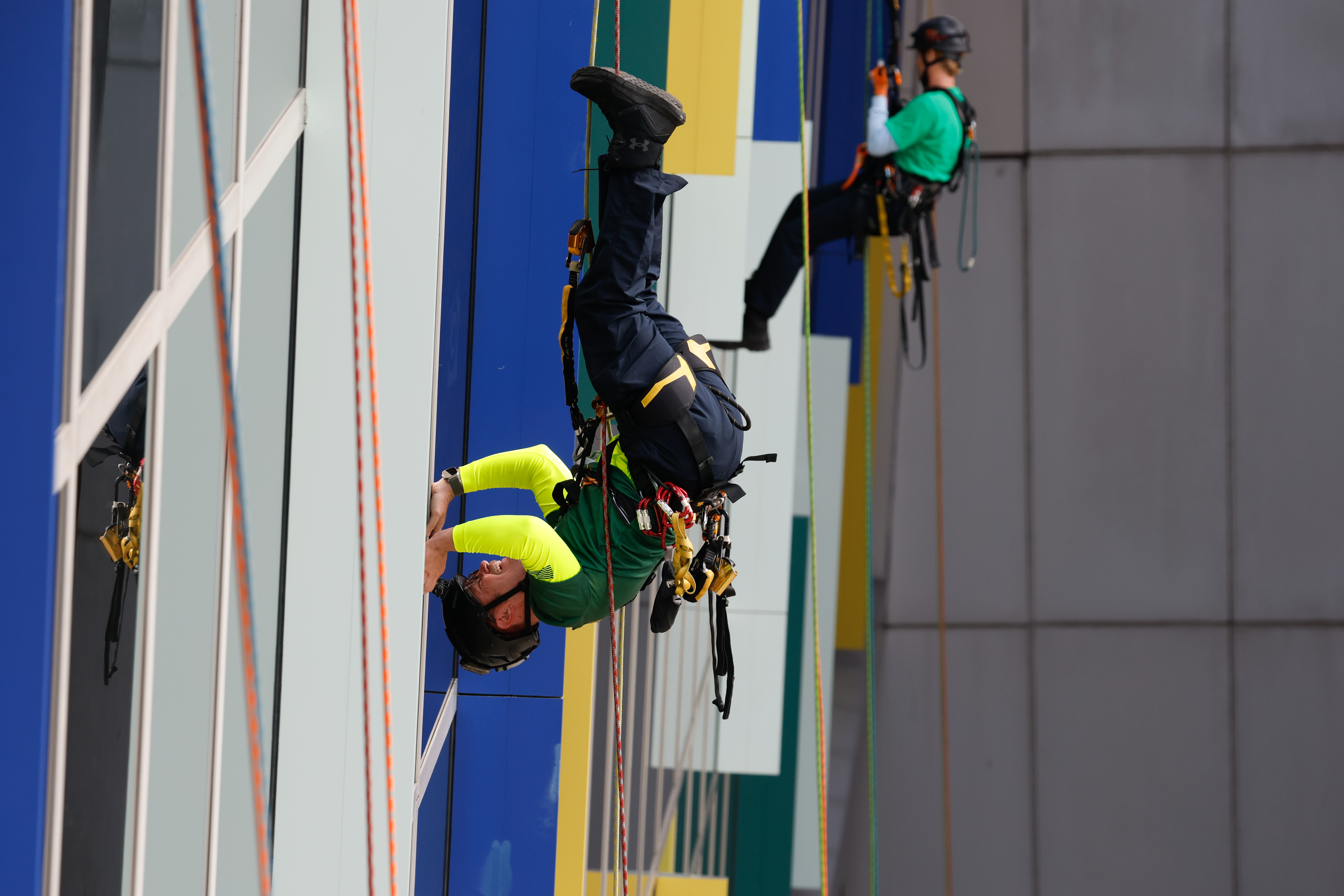 Orange County Fire Rescue and the Orlando Fire Department rappel down the side of AdventHealth for Children, interacting with children and their families through the windows on Thursday, December 18, 2025.(Rich Pope/Orlando Sentinel)