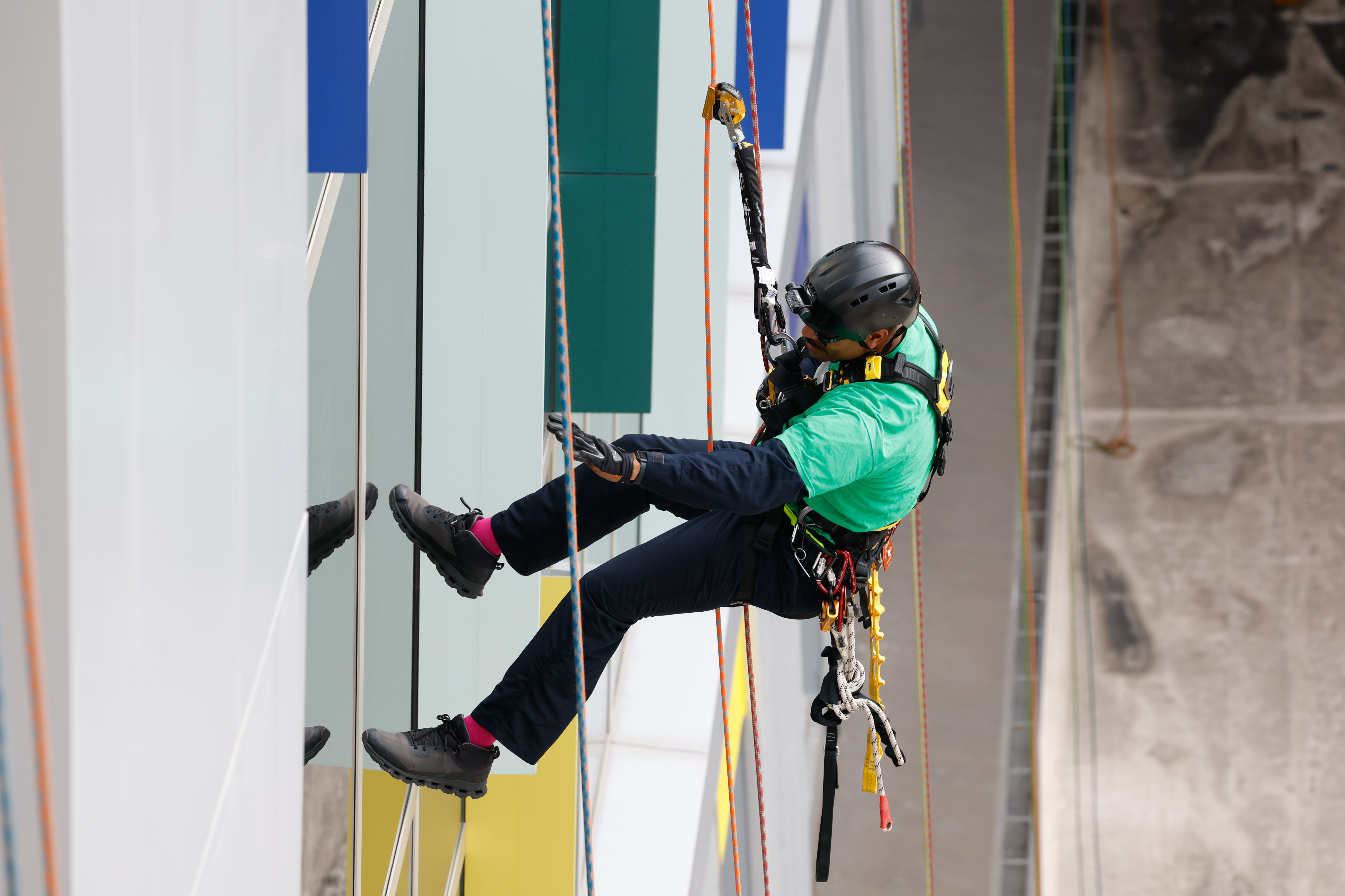Adam Garcia, from Orange County Fire Rescue, rappels down the side of AdventHealth for Children, interacting with children and their families through the windows on Thursday, December 18, 2025. (Rich Pope/Orlando Sentinel)