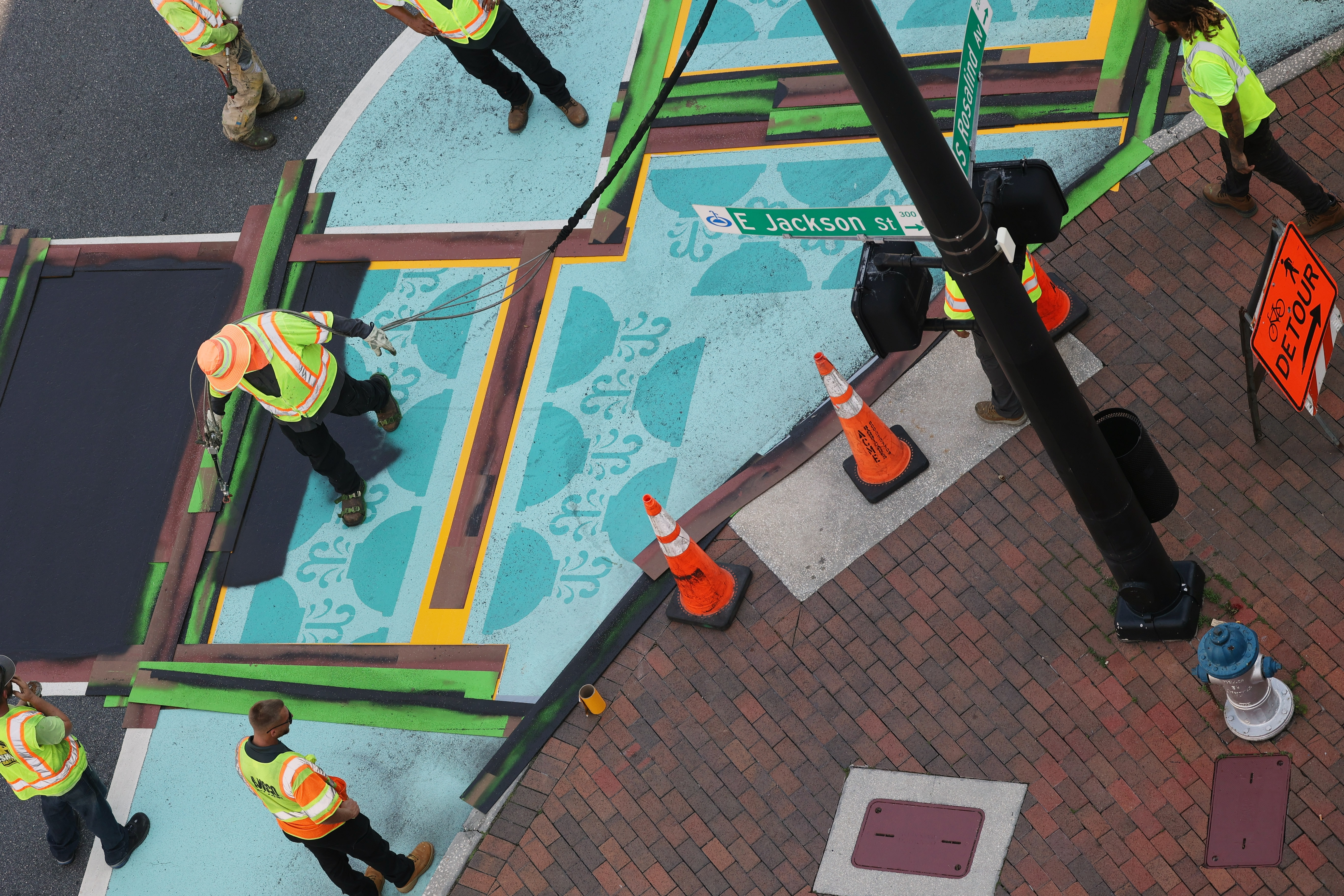 Contractors cover art on the crosswalk at the intersection of...