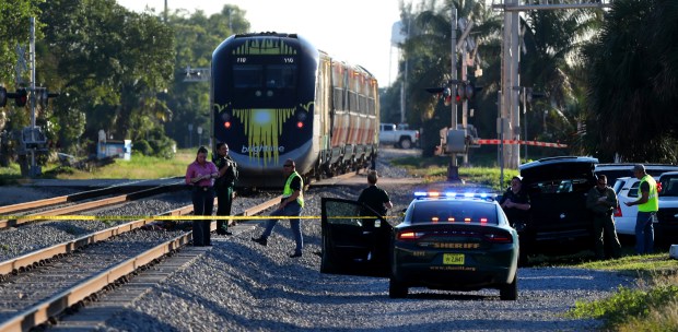Broward Sheriff's officials on the scene where a pedestrian was killed by a Brightline train along Southwest Third Street and Dixie Highway in Pompano Beach on Jan. 1, 2020. Without fencing in stretches like this one, pedestrians find it easy to tempt fate - accidentally or deliberately. (Carline Jean/South Florida Sun Sentinel file)