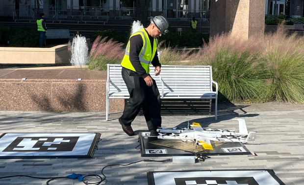 Wing Flight Operations Support Coordinator, Joshua Lorenzo Simonetti, works with a Wing drone at a demonstration outside City Hall on Tuesday, December 16, 2025. (Michael Cuglietta/Orlando Sentinel)