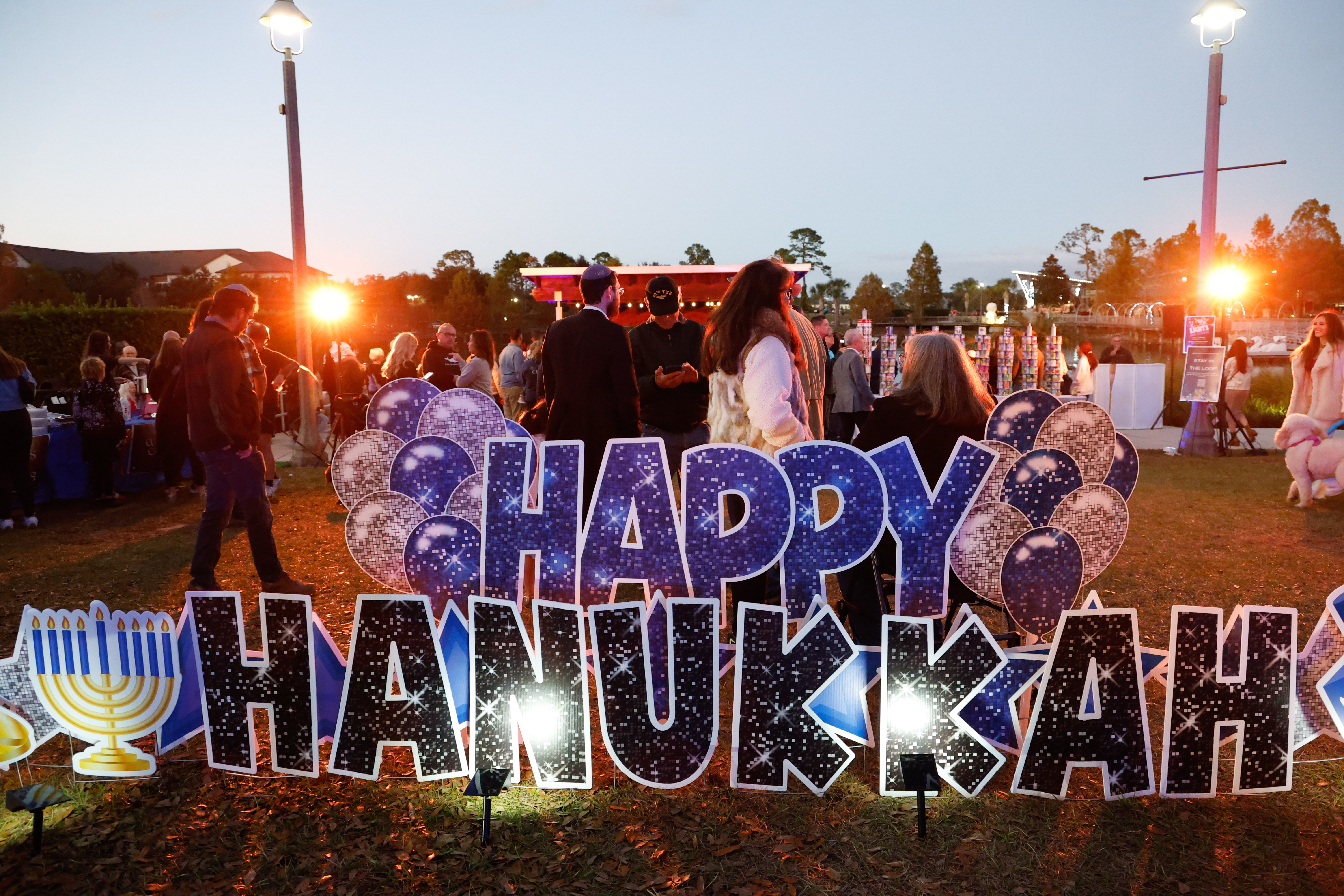 A photo op background is set up at the Hanukkah...