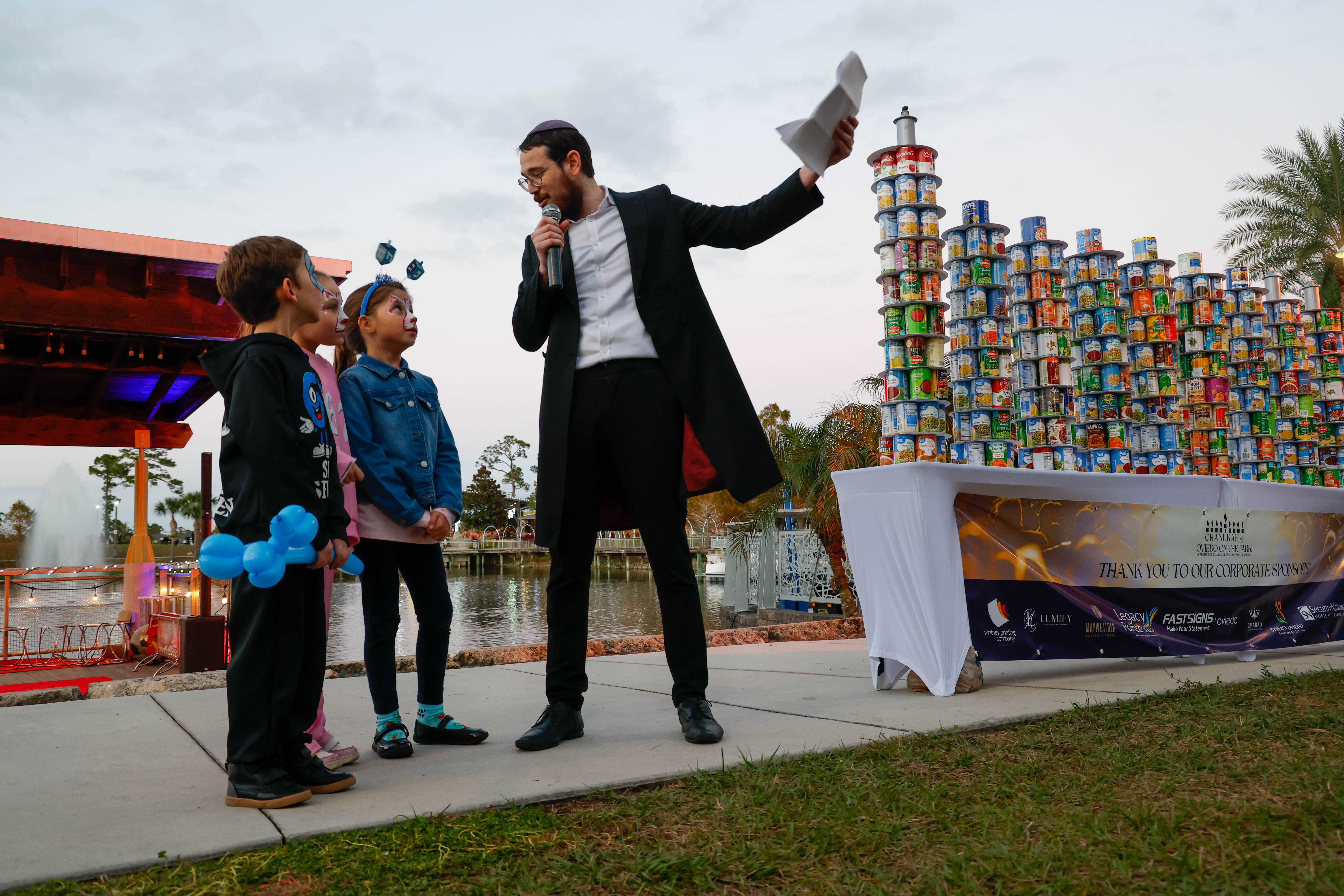 Rabbi Tzvi Dubov gets some help telling the story of...
