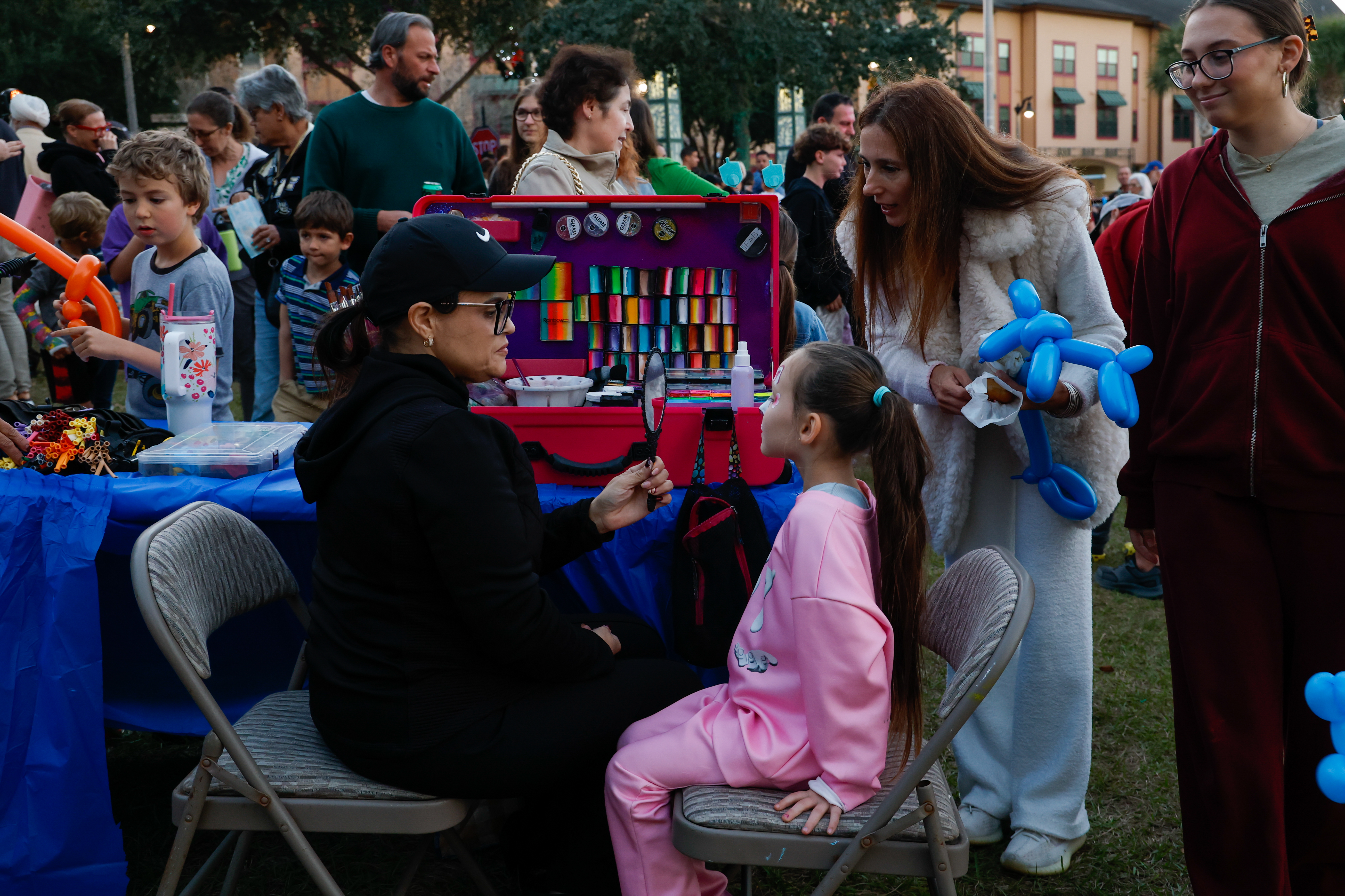 Katherine Pollack gets her face painted during the Hanukkah celebration...