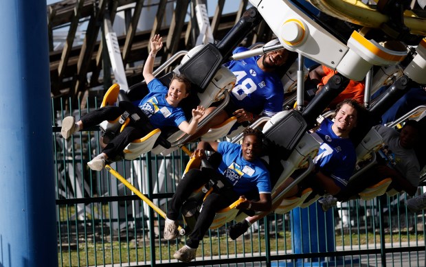 Football players and Central Florida children ride the Freedom Flyer during children's day for the 36th annual Pop-Tarts Bowl teams at Fun Spot America, on Tuesday. (Ricardo Ramirez Buxeda/Orlando Sentinel)