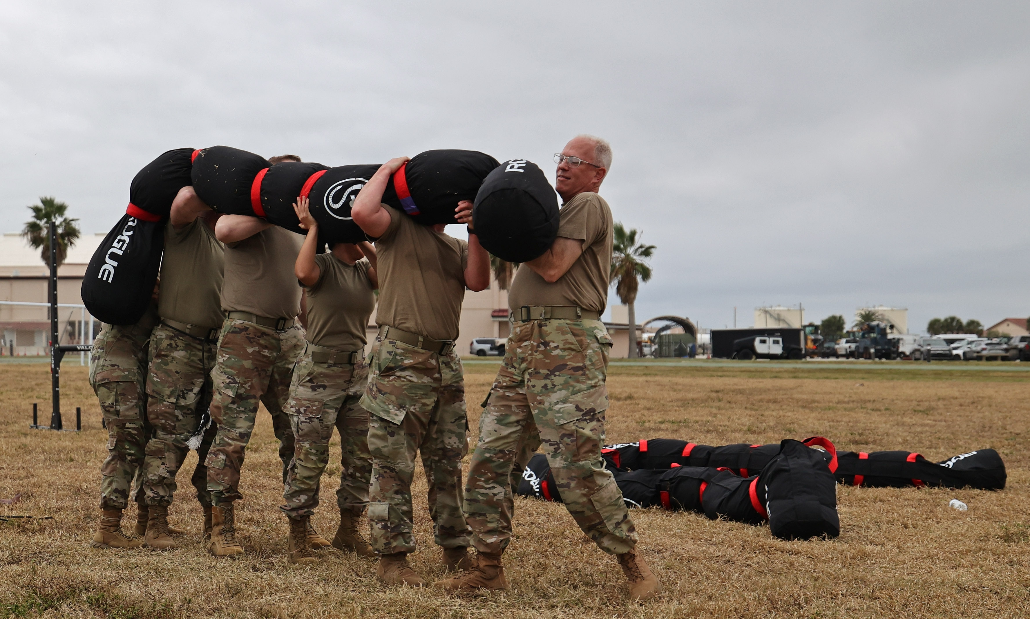 A group of senior Space Force officers lift a sandworm...