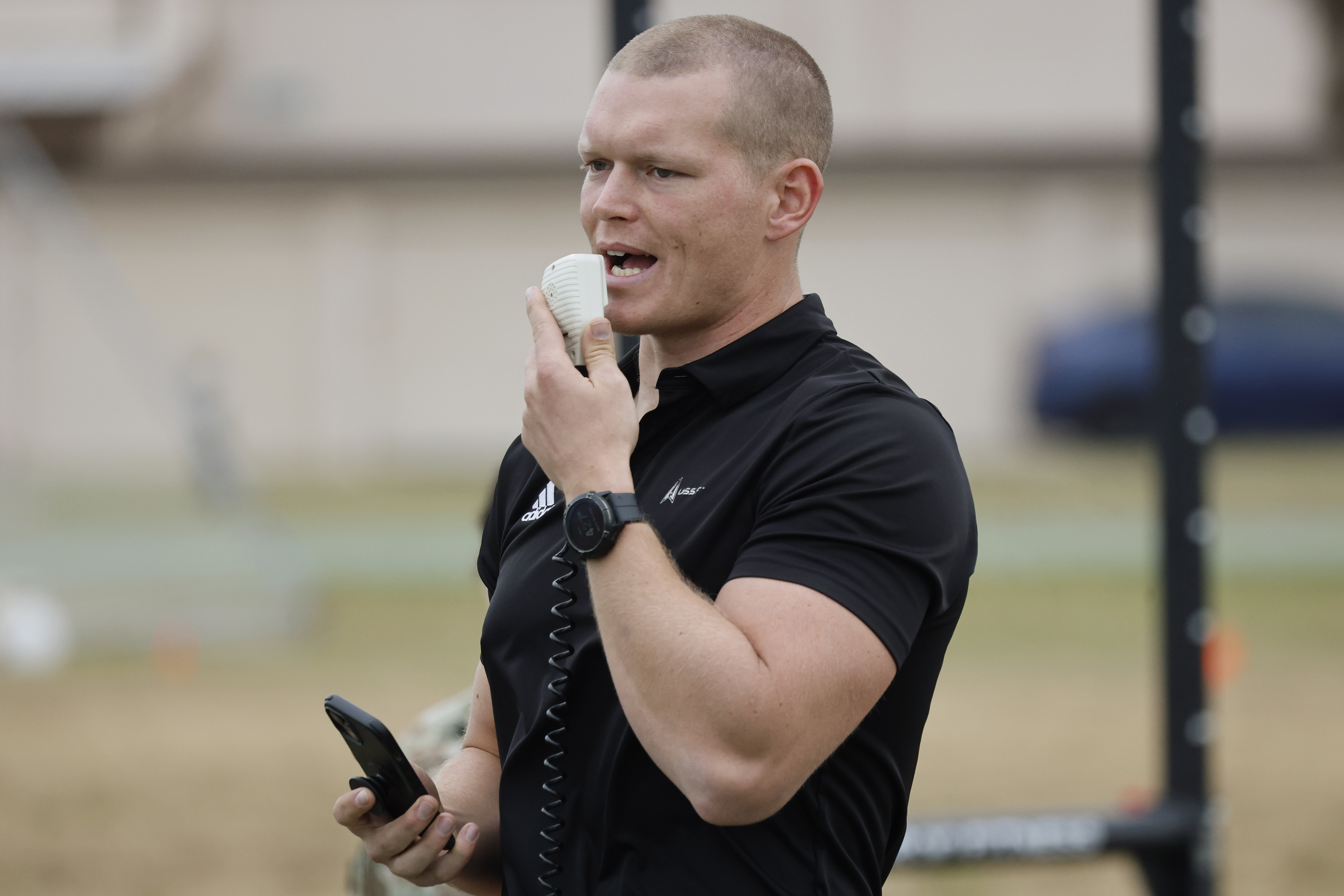 Coach Adam Whisler addresses the competitors during the first day...