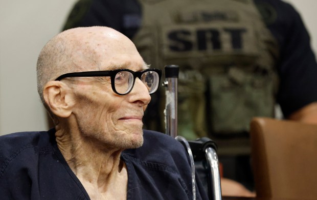 Tommy Zeigler is brought in on a wheelchair for an...