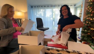 Britta Hammond and Olivia Hoegstrom wrap presents for Christmas. (Spectrum News)