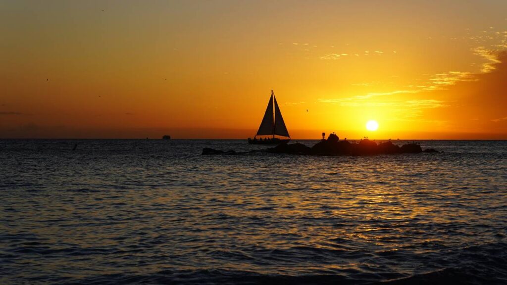 Sailboat sails during a beautiful sunset on the sea in Key West, FL