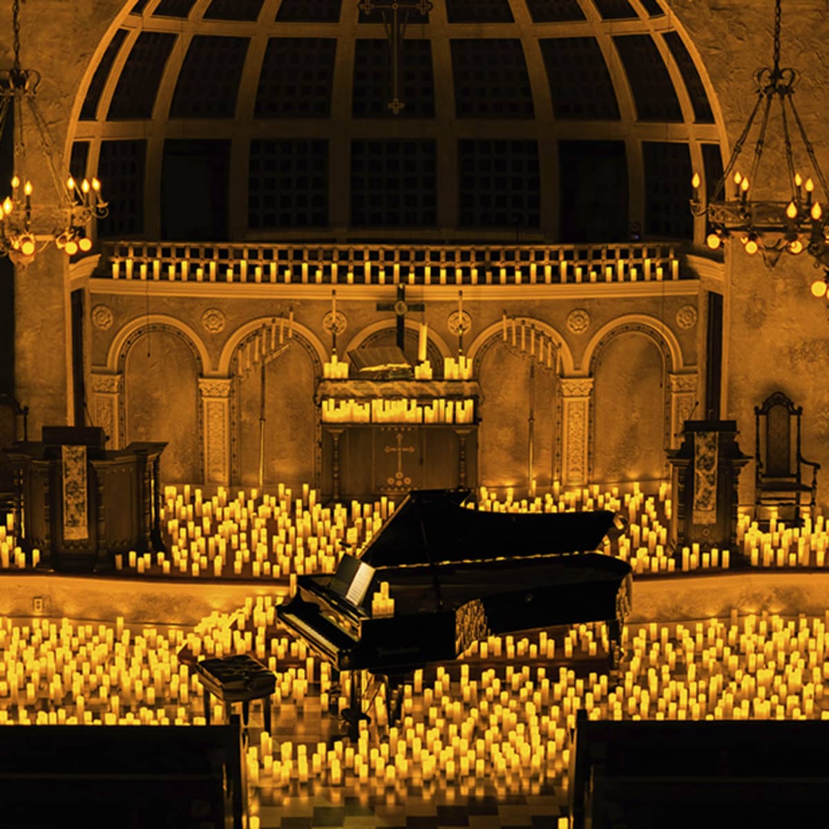A pianist performs amidst a sea of candles at a Candlelight concert at Coral Gables.