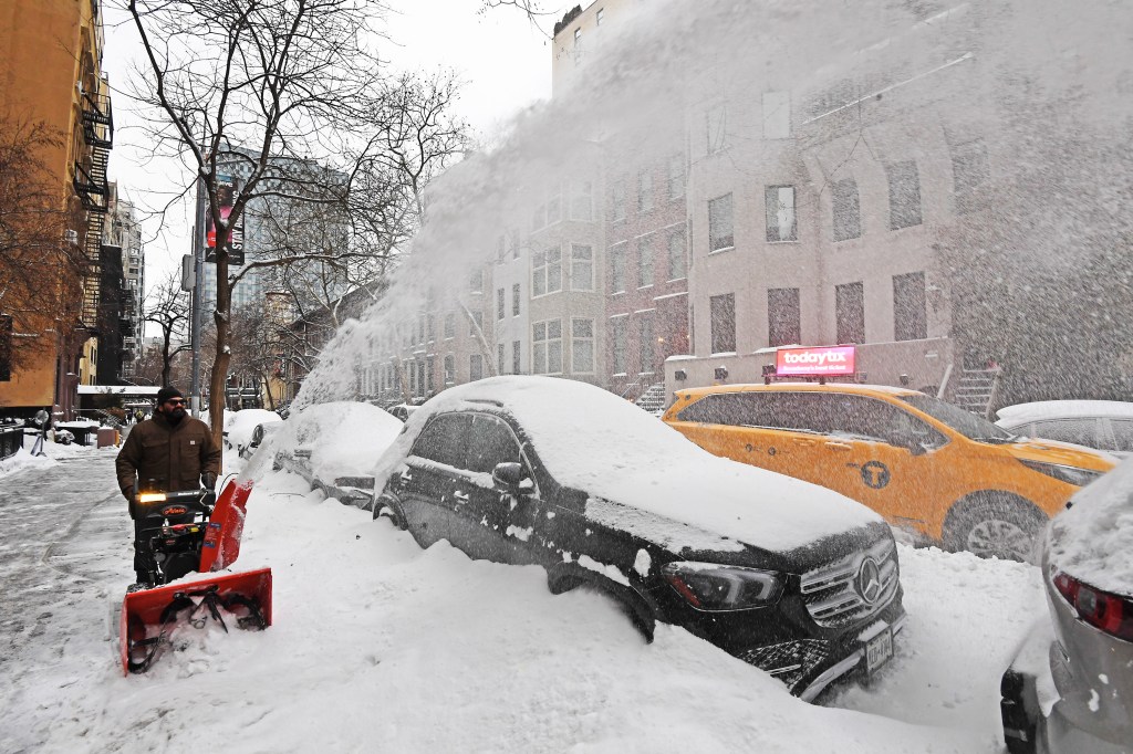 A New Yorker clearing snow from the sidewalk on Third Avenue in Manhattan on Jan. 26, 2026.