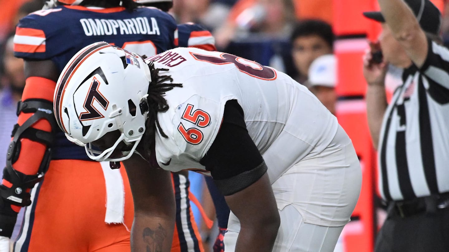 Nov 2, 2024; Syracuse, New York, USA; Virginia Tech Hokies offensive lineman Xavier Chaplin (65) looks after quarterback Collin Schlee (3) who was shaken up on a play against the Syracuse Orange in the fourth quarter at JMA Wireless Dome. Mandatory Credit: Mark Konezny-Imagn Images
