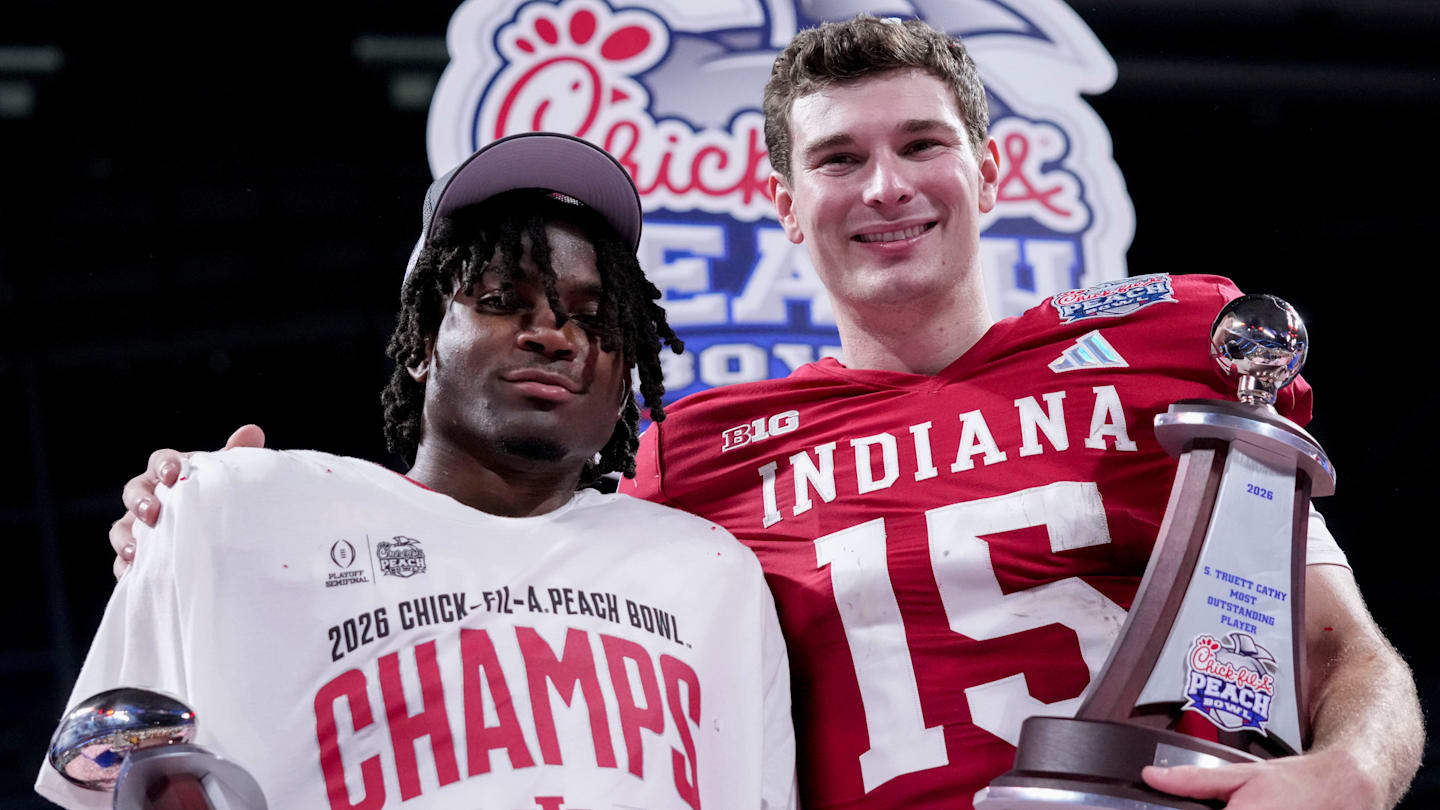 Indiana Hoosiers defensive back D'Angelo Ponds (5) and Indiana Hoosiers quarterback Fernando Mendoza (15) pose for photographs Friday, Jan. 9, 2026, after defeating the Oregon Ducks in the Peach Bowl and semifinal game of the College Football Playoff at Mercedes-Benz Stadium in Atlanta.