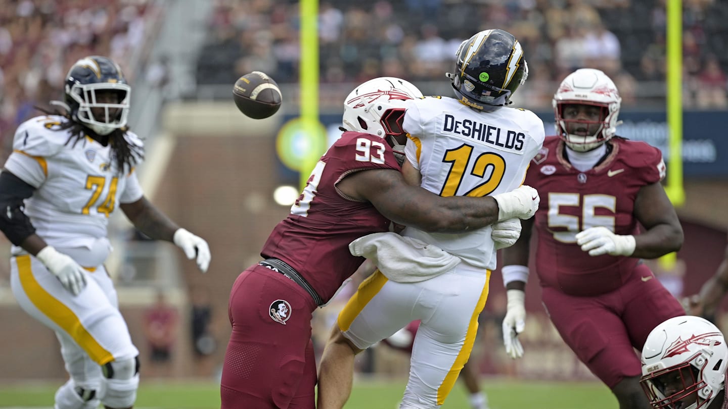 Sep 20, 2025; Tallahassee, Florida, USA; Kent State Golden Flashes quarterback Dru DeShields (12) is hit as he throws the ball by Florida State Seminoles defensive lineman Mandrell Desir (93) during the first half at Doak S. Campbell Stadium. Mandatory Credit: Melina Myers-Imagn Images