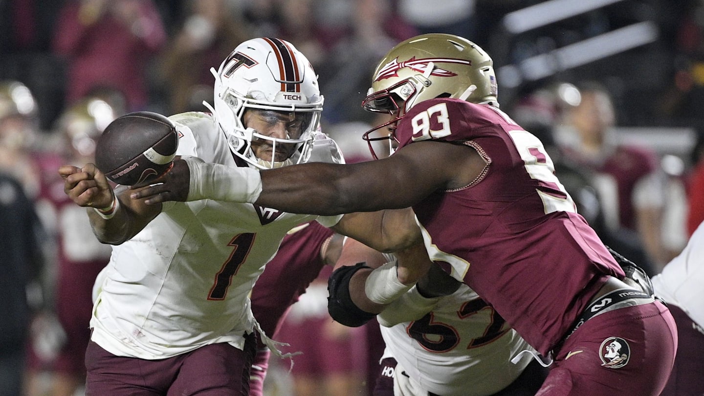 Nov 15, 2025; Tallahassee, Florida, USA; Virginia Tech Hokies quarterback Kyron Drones (1) has the ball knocked away by Florida State Seminoles defensive lineman Mandrell Desir (93) during the second half at Doak S. Campbell Stadium. Mandatory Credit: Melina Myers-Imagn Images