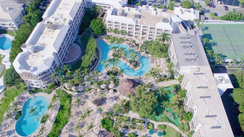 Sprawling beach resort with pools, tennis courts, and private beach area.